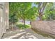 View of the front yard from the patio with green grass and mature trees, providing a peaceful setting at 2288 S Depew St, Lakewood, CO 80227
