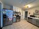 Kitchen with stainless steel appliances and grey cabinets at 11856 E 7Th Ave, Aurora, CO 80010