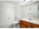 Clean bathroom featuring tiled walls, combination tub and shower, and vanity at 3335 S Ammons St # 6-102, Lakewood, CO 80227