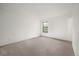 Empty bedroom with neutral carpet, white walls, and a single window at 3335 S Ammons St # 6-102, Lakewood, CO 80227