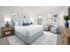 Stylishly furnished bedroom with a blue bed, side tables, and artwork, creating a serene atmosphere at 3335 S Ammons St # 6-102, Lakewood, CO 80227