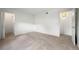 Bright, carpeted bedroom with open doorways leading to closet and bathroom areas at 3335 S Ammons St # 6-102, Lakewood, CO 80227