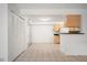 Dining area with tiled floors, closet doors, and a bar overlooking the kitchen area at 3335 S Ammons St # 6-102, Lakewood, CO 80227