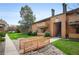 Well-maintained condo exterior with a charming bridge walkway and lush, green landscaping at 3335 S Ammons St # 6-102, Lakewood, CO 80227