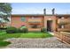 Inviting condo exterior with maintained landscape, balconies, and staircase leading to the building's entrance at 3335 S Ammons St # 6-102, Lakewood, CO 80227