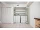 Laundry area with mirrored closet doors, tile flooring, and a washer and dryer at 3335 S Ammons St # 6-102, Lakewood, CO 80227