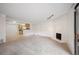 Open-concept living room and kitchen featuring a white brick fireplace and ample natural light at 3335 S Ammons St # 6-102, Lakewood, CO 80227