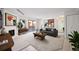 Bright living room featuring a fireplace with white brick, modern art, and a sliding glass door at 3335 S Ammons St # 6-102, Lakewood, CO 80227