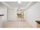 Bright living room with tiled floor, mirrored closet, and view of the kitchen at 3335 S Ammons St # 6-102, Lakewood, CO 80227