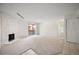 Expansive living room with neutral carpet, fireplace, and sliding glass door at 3335 S Ammons St # 6-102, Lakewood, CO 80227