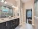 Modern bathroom with double vanity, sleek cabinets, and an open shower with decorative tiles and natural light at 5590 W 97Th Ave, Westminster, CO 80020