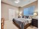 Comfortable bedroom features neutral colors, large window, and bedside lamps at 5590 W 97Th Ave, Westminster, CO 80020