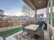 Covered patio with dining set, grill, and view of the fenced backyard at 5590 W 97Th Ave, Westminster, CO 80020