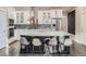 Modern kitchen with a large center island, stainless steel appliances, and white cabinetry at 5590 W 97Th Ave, Westminster, CO 80020