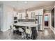 Modern kitchen with a large center island, stainless steel appliances, and white cabinetry at 5590 W 97Th Ave, Westminster, CO 80020
