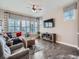 Cozy living room with hardwood floors, large windows, comfortable seating, and a stylish coffee table at 5590 W 97Th Ave, Westminster, CO 80020
