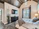 Comfortable main bedroom with wood-beam ceiling, mounted TV, and large windows allowing for plenty of light at 5590 W 97Th Ave, Westminster, CO 80020