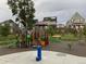 Community playground area with slides, climbing structures, and swings surrounded by well-maintained landscaping at 5590 W 97Th Ave, Westminster, CO 80020
