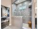 Luxurious shower with glass enclosure, neutral tile, and decorative accent tiles with access to the Primary bedroom at 5590 W 97Th Ave, Westminster, CO 80020