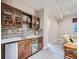 Modern wet bar with custom cabinets, mosaic backsplash, and beverage refrigerator at 5590 W 97Th Ave, Westminster, CO 80020