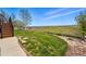 Spacious backyard with a wooden fence and a pathway with scenic views at 12996 Banyon Cir, Parker, CO 80134