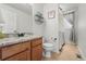 Cozy bathroom with vanity and granite countertop and a view into the laundry room with a washer and dryer at 12996 Banyon Cir, Parker, CO 80134