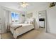 Bedroom with natural light, white bedding, and standing mirror at 12996 Banyon Cir, Parker, CO 80134