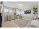 Bright bedroom with a neutral color palette features modern decor, ample natural light, and a stylish rug at 12996 Banyon Cir, Parker, CO 80134