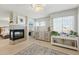 Stylish primary bedroom features a modern fireplace, a neutral color scheme, and abundant natural light at 12996 Banyon Cir, Parker, CO 80134