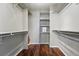Walk-in closet with hardwood floors and built-in shelving at 12996 Banyon Cir, Parker, CO 80134