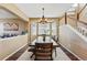 Bright dining room with a large wooden table and views of the surrounding landscape at 12996 Banyon Cir, Parker, CO 80134