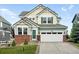 Charming two-story house showcasing green shutters, a well-kept lawn, and an attached two-car garage at 12996 Banyon Cir, Parker, CO 80134