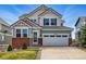 Charming two-story home with brick accents, an attached two-car garage and manicured lawn at 12996 Banyon Cir, Parker, CO 80134