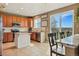 Bright eat-in kitchen features tile floors, island with granite countertop, stainless steel appliances, and outdoor views at 12996 Banyon Cir, Parker, CO 80134