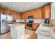 Spacious kitchen with stainless steel appliances, granite countertops, tile backsplash, and an island at 12996 Banyon Cir, Parker, CO 80134