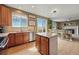 Open kitchen layout with granite countertops, stainless steel appliances, large window, and access to the backyard at 12996 Banyon Cir, Parker, CO 80134
