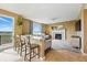 Open concept living room, fireplace, bar seating, and views of rolling hills at 12996 Banyon Cir, Parker, CO 80134