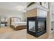 Light-filled main bedroom boasts a fireplace, neutral decor, and a comfortable bed at 12996 Banyon Cir, Parker, CO 80134