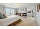 Spacious bedroom featuring a cozy fireplace, a comfortable bed, and neutral colors for relaxation at 12996 Banyon Cir, Parker, CO 80134