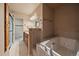 Elegant bathroom with a soaking tub and natural tile shower and vanity at 3672 Deer Creek Dr, Parker, CO 80138