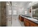 Bathroom featuring double sinks, a walk-in shower, and great natural light at 3672 Deer Creek Dr, Parker, CO 80138