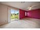 Bright bedroom featuring sliding glass doors with backyard and lawn views at 3672 Deer Creek Dr, Parker, CO 80138