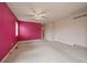 Large bedroom with a bright accent wall, carpet, and big window views at 3672 Deer Creek Dr, Parker, CO 80138