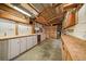A workshop interior featuring storage shelves, a workbench, and abundant space for tools and projects at 3672 Deer Creek Dr, Parker, CO 80138