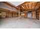 Unfinished garage interior featuring concrete floors, exposed wood framing and ceiling, plus potential for customization at 3672 Deer Creek Dr, Parker, CO 80138