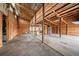 A spacious garage interior with exposed wood framing, offering ample room for storage or workshop space at 3672 Deer Creek Dr, Parker, CO 80138