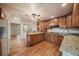 Spacious kitchen with wood floors, granite countertops, and ample cabinet space at 3672 Deer Creek Dr, Parker, CO 80138