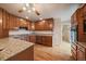 Well-lit kitchen featuring granite countertops, stainless steel appliances, and wooden cabinetry at 3672 Deer Creek Dr, Parker, CO 80138