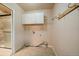 Laundry room with tile floors, washer/dryer hookups and built-in white cabinets at 3672 Deer Creek Dr, Parker, CO 80138