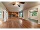 Living room with hardwood floors, stone fireplace, and access to other rooms at 3672 Deer Creek Dr, Parker, CO 80138